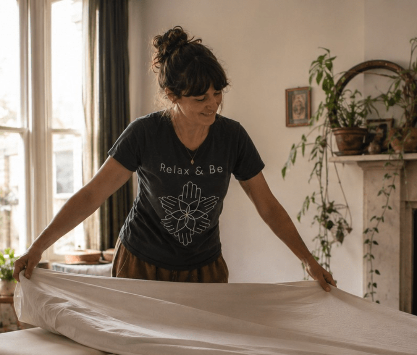 Relax & Be massage therapist preparing a massage table in a client’s home
